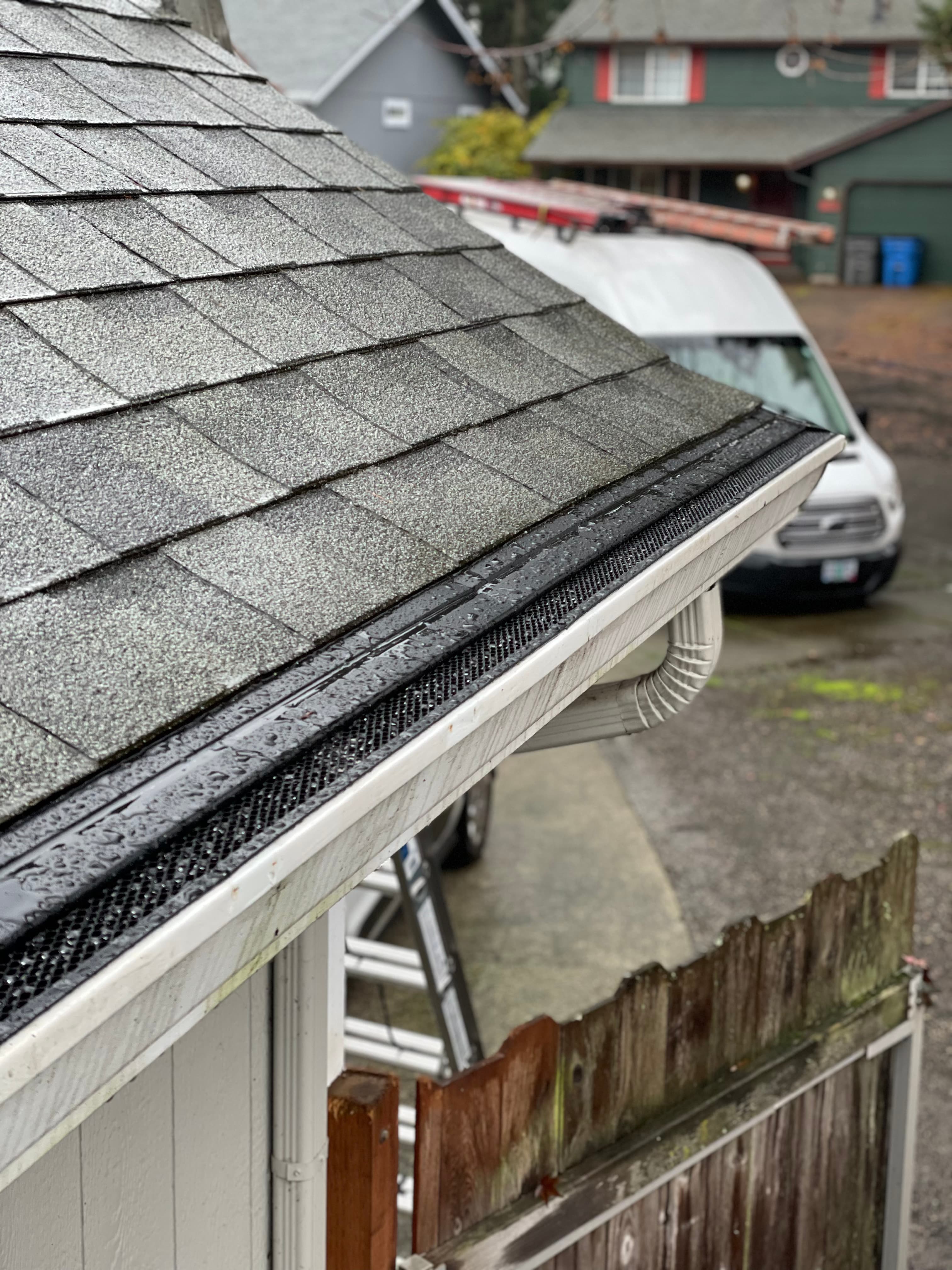 Close-up of Premier louvered gutter guards showing the angled aluminum design that handles heavy rainfall